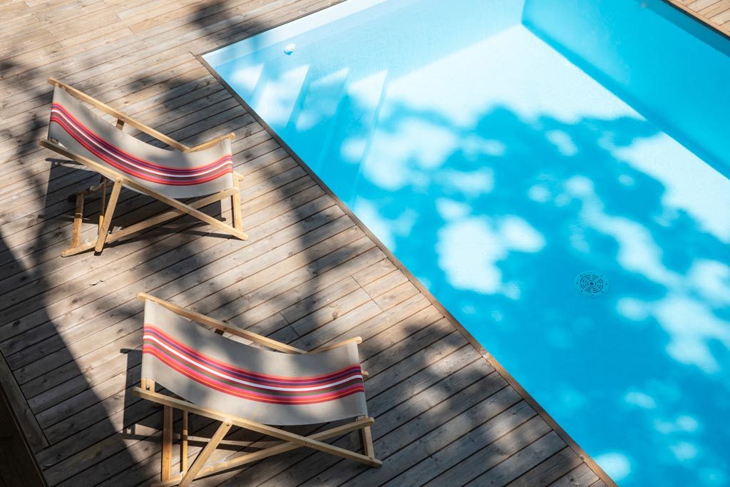 aménagement intérieur d'une maison bois familial avec piscine au millieu de la nature