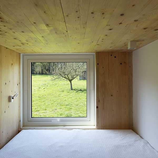 chambre à coucher avec fenêtre d'une maison bois