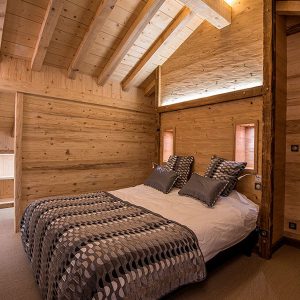 La chambre parentale, en bois, dans un chalet conçu par Décobois © Thomas Devard