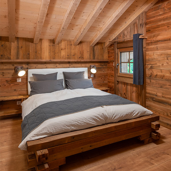 Une chambre parentale sobre, en bois, dans les Vosges